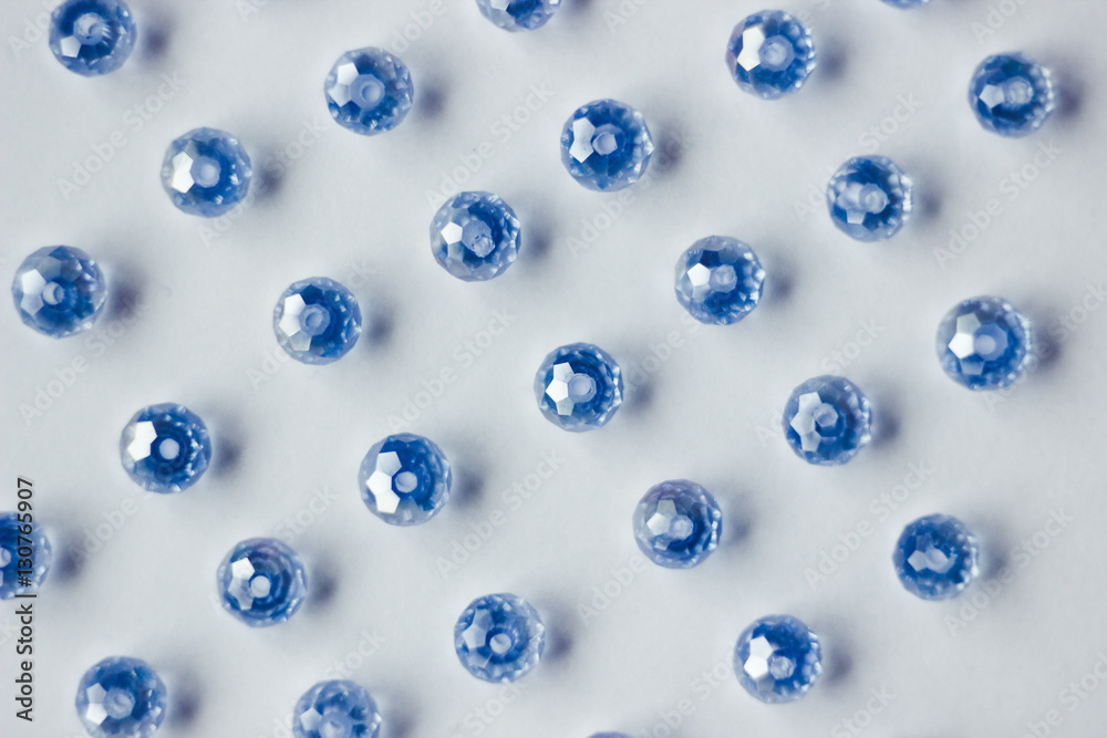 blue glass beads polyhedron shape pattern closeup on a white background blue glass beads polyhedron shape pattern closeup on a white background