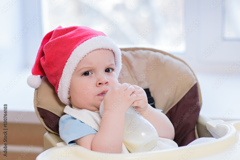 baby drinking milk in Christmas red hat baby drinking milk in Christmas red hat
