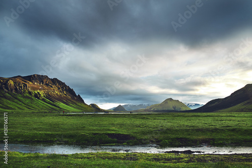 Travel to Iceland. Beautiful Icelandic landscape with mountains, sky and clouds. Trekking in national park Landmannalaugar. Rainy Evening in Camping near Alftavatn lake. photo