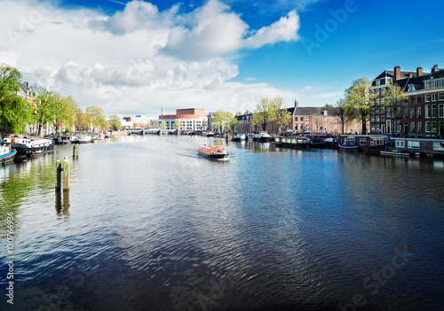 embankments of Amstel canal with traditional houses in Amsterdam  Netherlands  retro toned