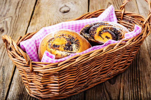 Buns with poppy seeds in a bread basket