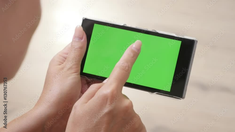Woman with greenscreen smart phone relaxing at home 4K 2160p 30fps UltraHD footage - Female lying down on floor and holds green screen display tablet 3840X2160 UHD video Woman with greenscreen smart phone relaxing at home 4K 2160p 30fps UltraHD footage - Female lying down on floor and holds green screen display tablet 3840X2160 UHD video