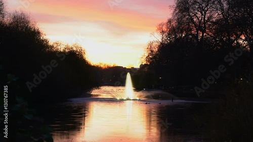 Beautiful fountain at St James s Park in London at sunset photo