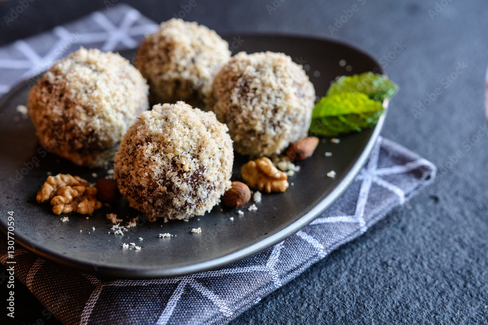 Unbaked sweet balls made of walnut, cocoa and almond