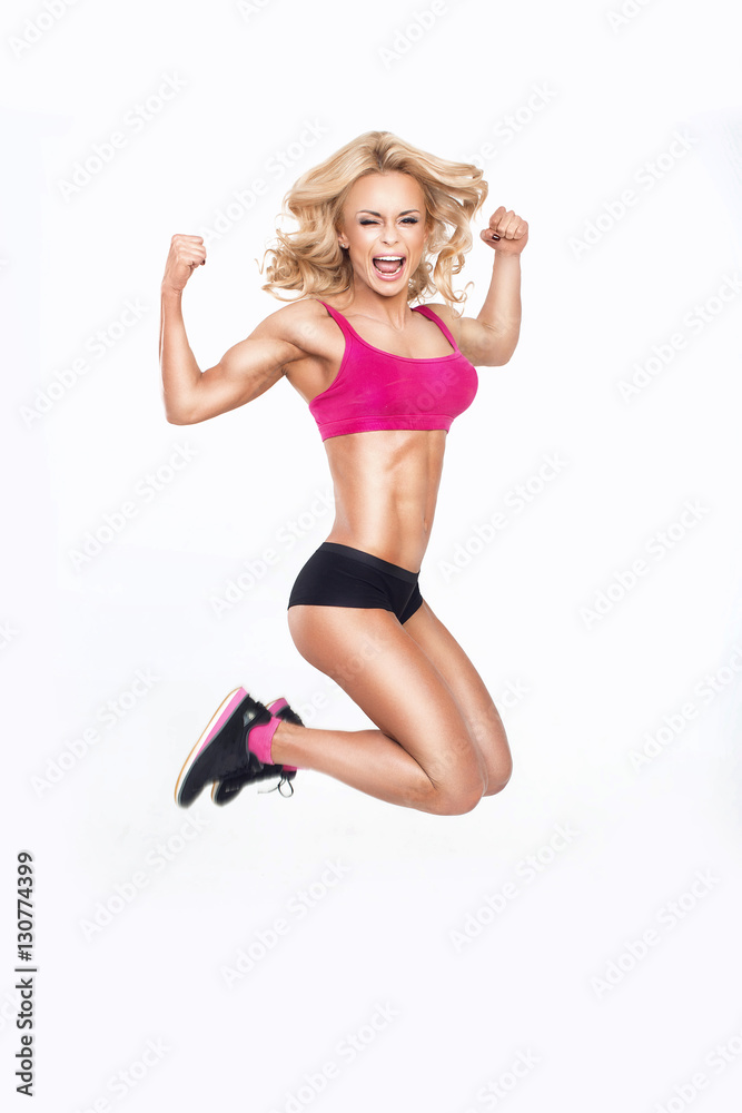 Young beautiful woman jumps in a gym outfit. Young beautiful woman jumps in a gym outfit.