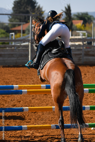 Rider on horse jumping over a hurdle during the equestrian event