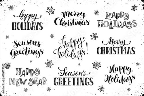 Hand written New Year phrases. Greeting card text  with snowflakes isolated on white background. Happy holidays lettering in modern calligraphy style. Merry Christmas and Season's Greetings lettering.