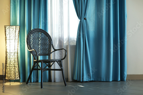Chair, lamp and room window...