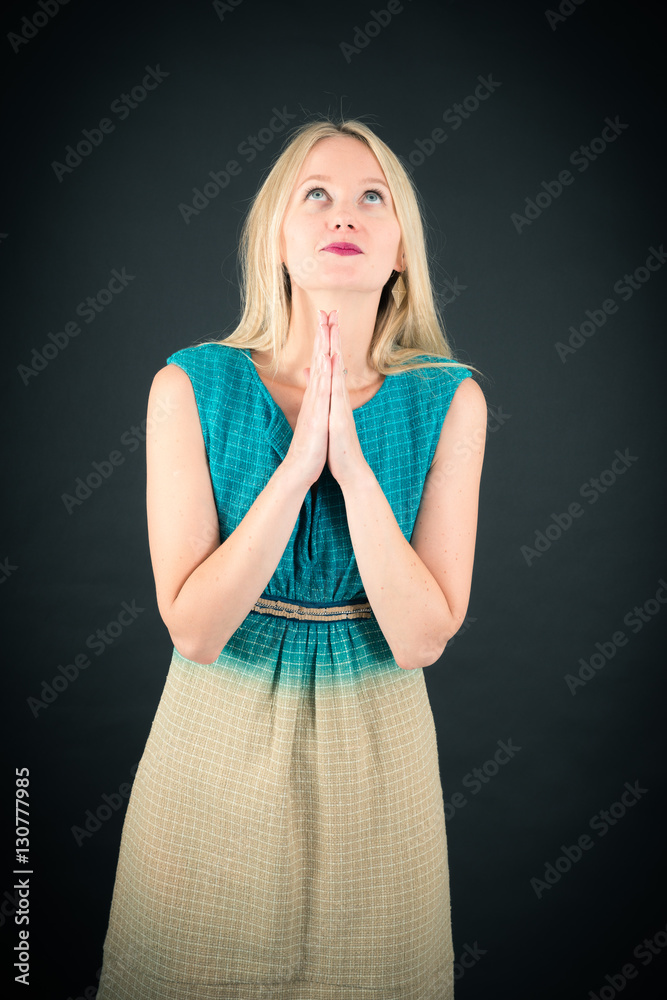 Beautiful woman doing different expressions in different sets of clothes: prayer Beautiful woman doing different expressions in different sets of clothes: prayer