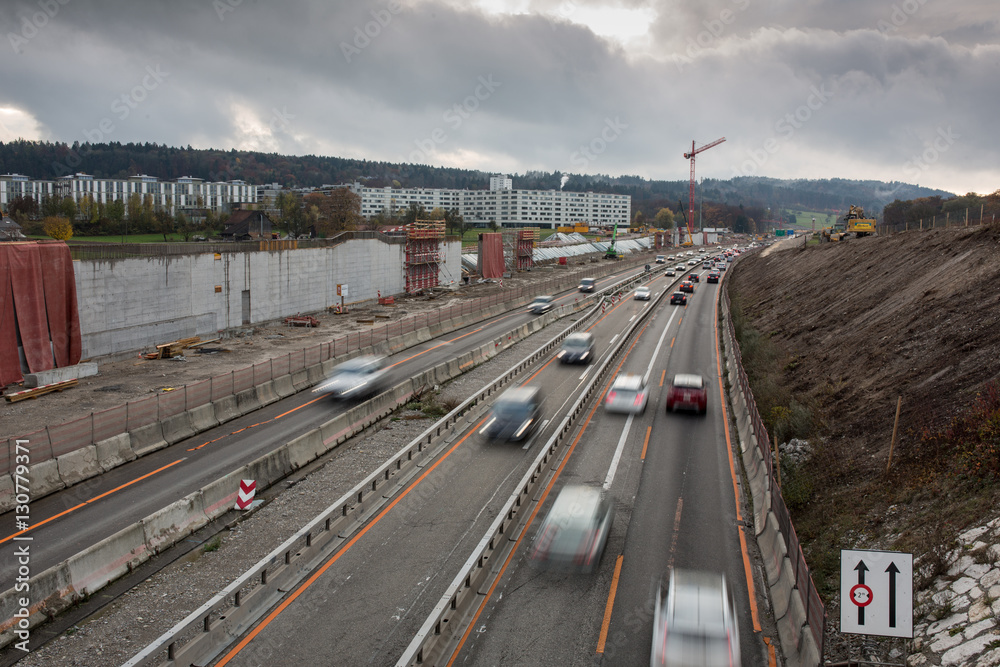 Automobile traffic on a highway under construction. Motion blurred image.