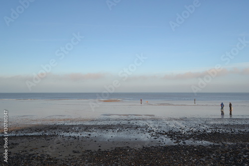 winter seascape fog tide out pebbled beach sand  © michelle