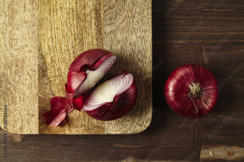 Red bisect onion on wooden table. Close-up from above. Red bisect onion on wooden table. Close-up from above.