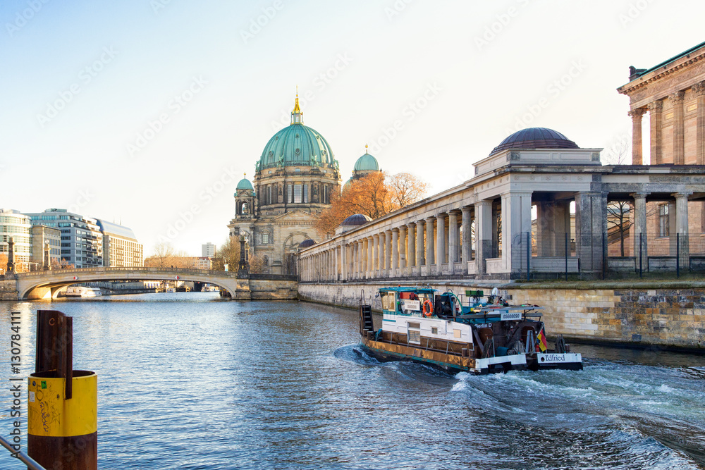 Berlin - December 2016: Small boat in front of Berlin Cathedral (Berliner Dom) and Museum Island (Museumsinsel) reflected in Spree River, Berlin, Germany, Europe.
