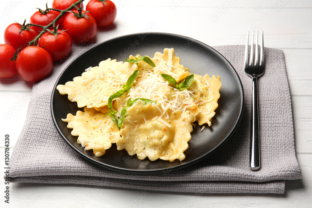 Plate of ravioli with cheese on table Plate of ravioli with cheese on table