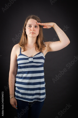 Beautiful woman doing different expressions in different sets of clothes: at attention