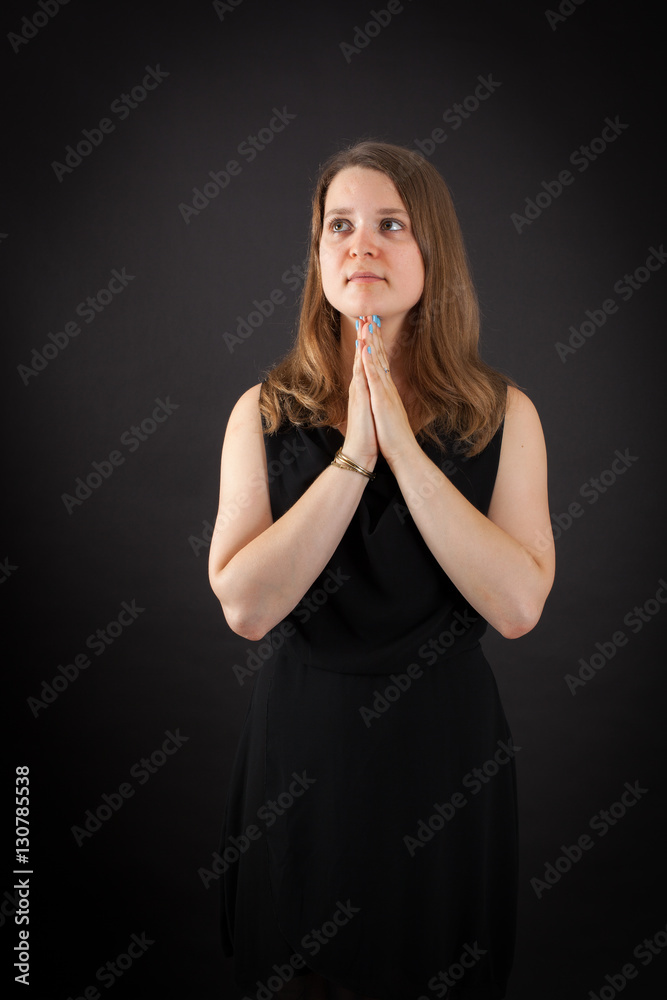 Beautiful woman doing different expressions in different sets of clothes: prayer Beautiful woman doing different expressions in different sets of clothes: prayer