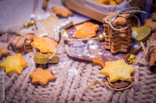 Gingerbread and sugar stars cookies on knitted background