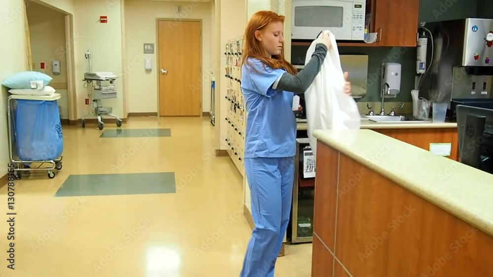 Female Doctor removing coat and going to change into street clothes.
Female Doctor removing coat and going to change into street clothes.