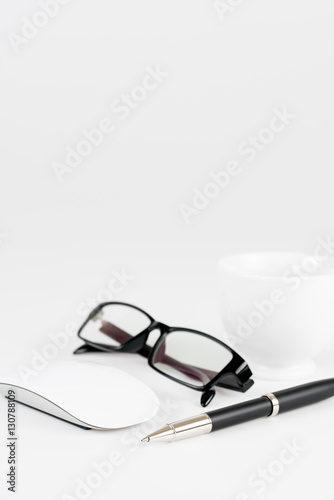 cup of coffee, pen, mouse and glasses, on a background