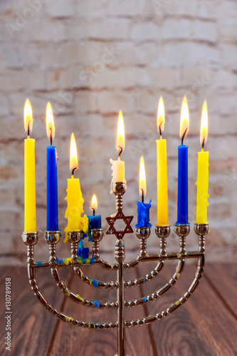 jewish holiday Hanukkah with menorah over wooden background
