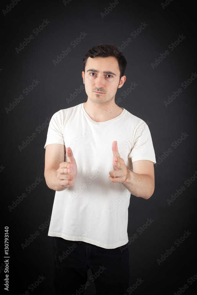 Handsome Man doing different expressions in different sets of clothes: gun sign Handsome Man doing different expressions in different sets of clothes: gun sign