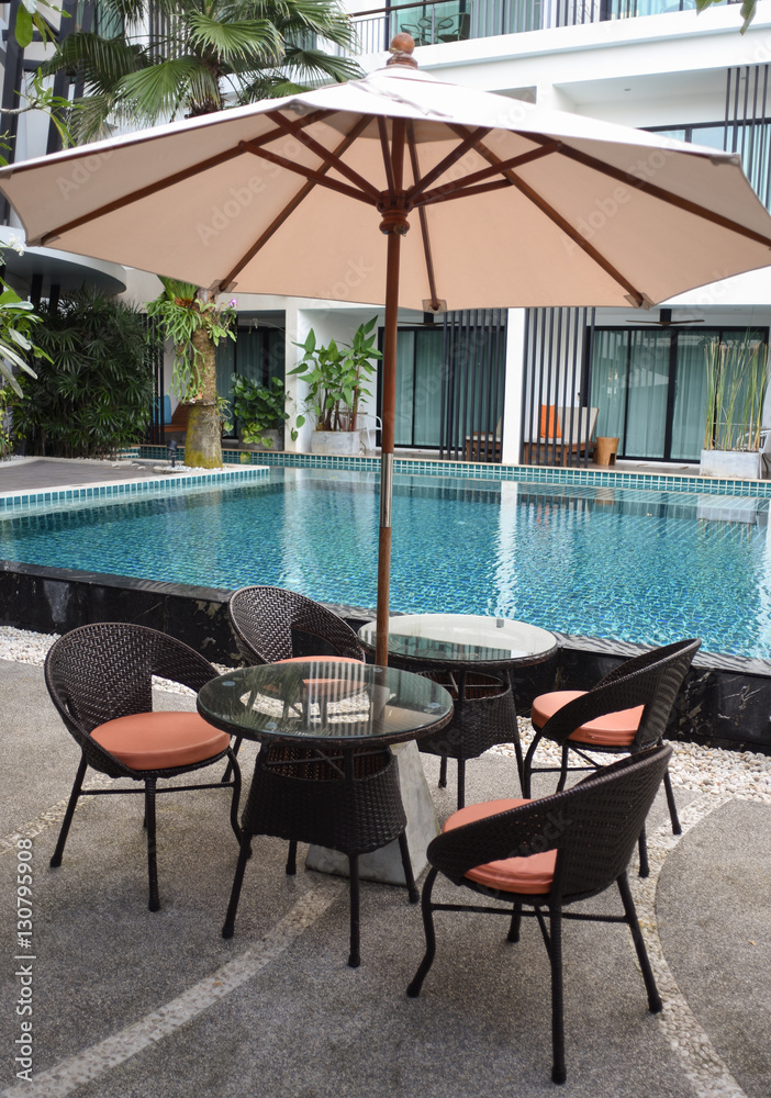 Relaxing rattan chairs beside swimming pool