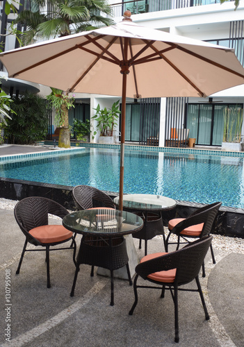 Relaxing rattan chairs beside swimming pool