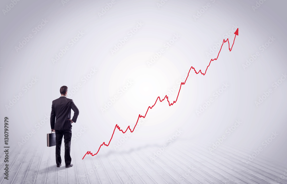 Standing businessman with red graph arrow Standing businessman with red graph arrow