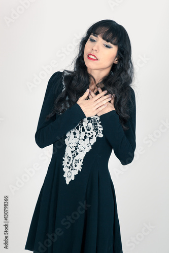 Beautiful woman doing different expressions in different sets of clothes: heart attack