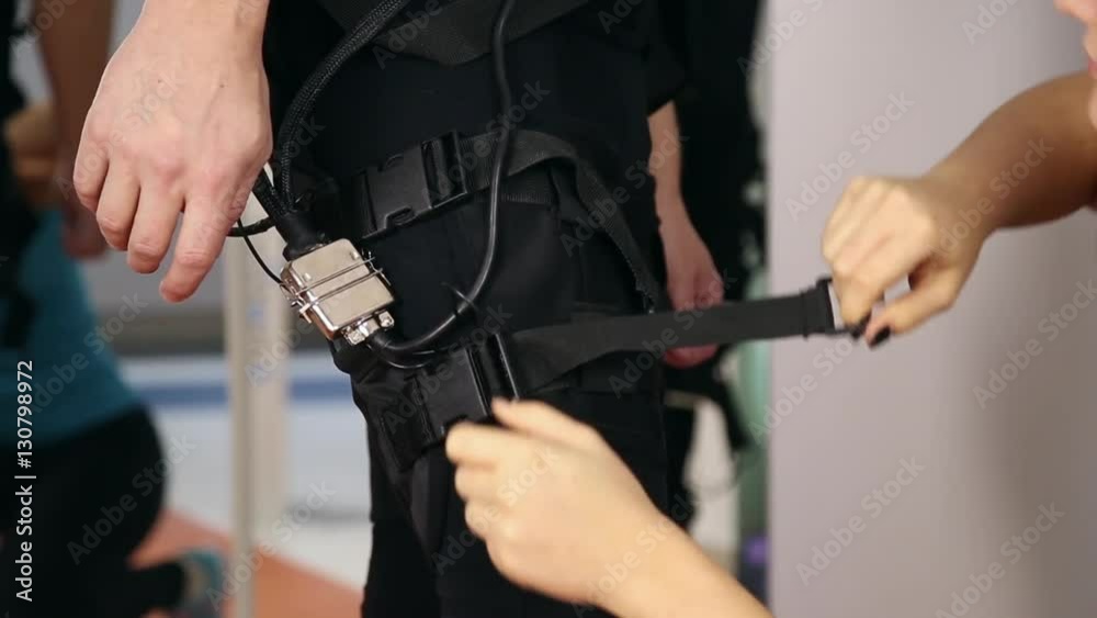 Personal ems training in the gym, trainer puts ems training equipment for the athlete
Personal ems training in the gym, trainer puts ems training equipment for the athlete