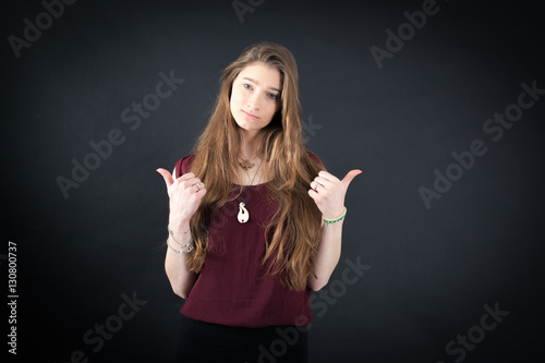 Beautiful woman doing different expressions in different sets of clothes: thumbs up