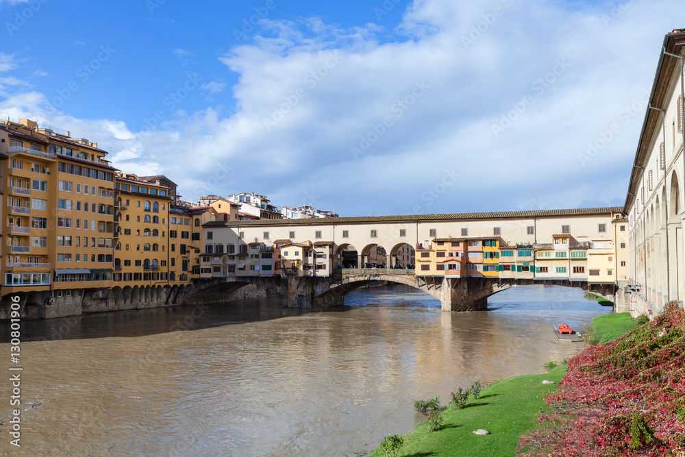 Ponte Vecchio over Arno river in sunny autumn day