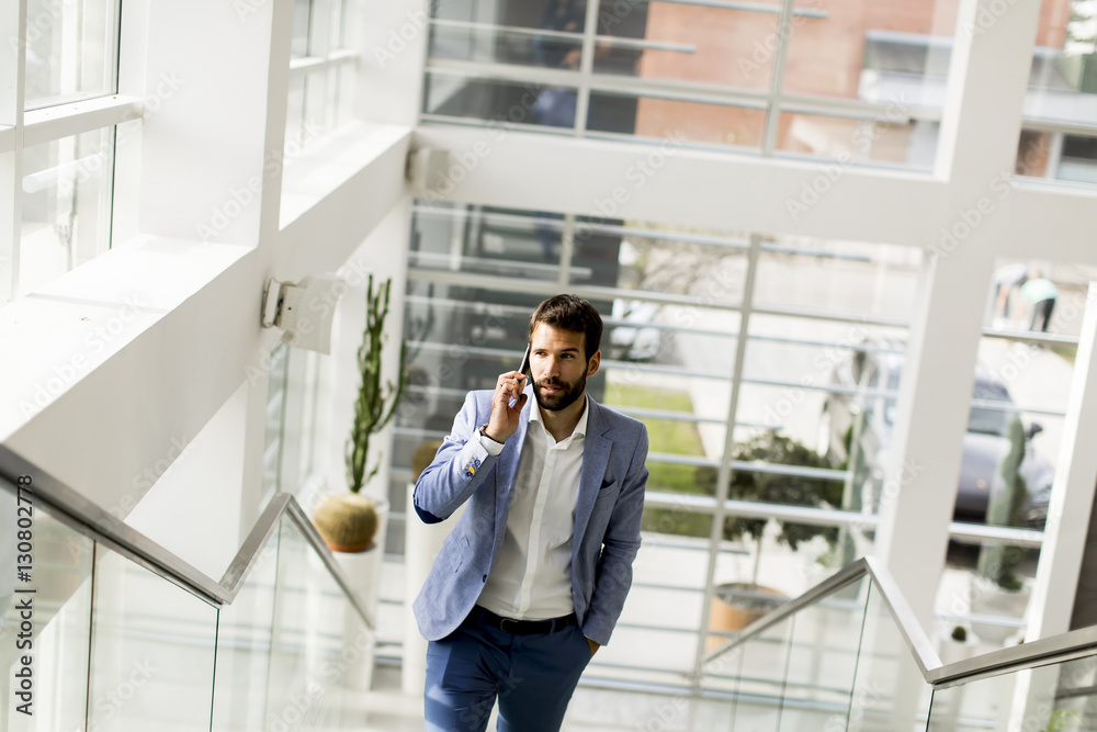 Handsome businessman in suit using the phone Handsome businessman in suit using the phone