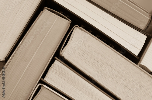 Abstract - stack of old books side view - sepia