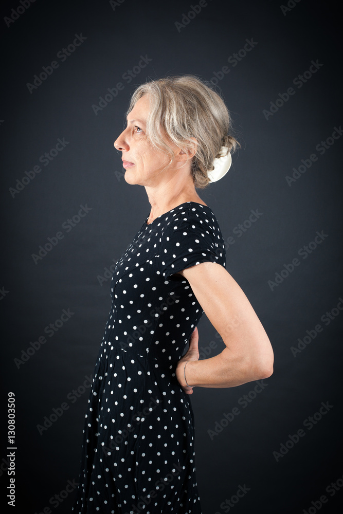 Beautiful woman doing different expressions in different sets of clothes: backache Beautiful woman doing different expressions in different sets of clothes: backache