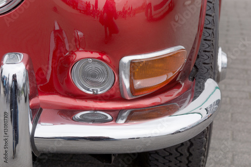 Closeup of red old retro car head lights