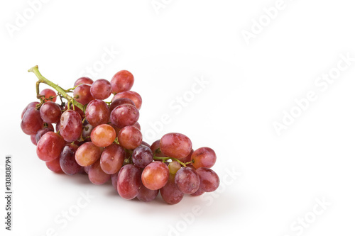 Fresh purple grapes on a white background