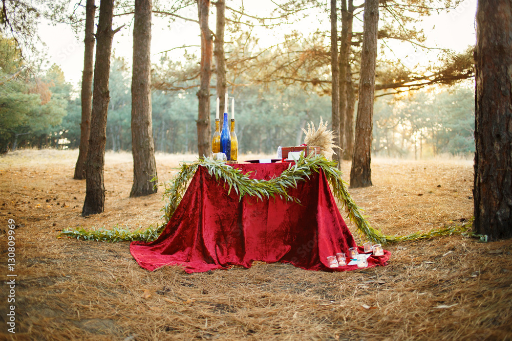 Table with candles and tea in the forest Table with candles and tea in the forest