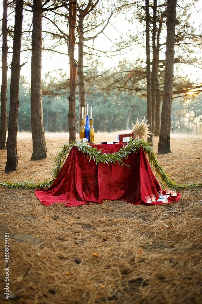 Table with candles and tea in the forest Table with candles and tea in the forest