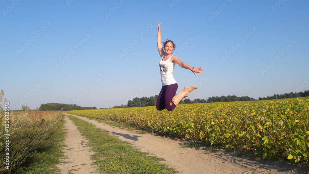 Fototapeta premium Jumping girl on the road