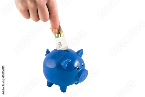 Woman's hand putting deposit into piggybank photo