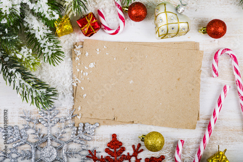 Christmas decoration and old paper on brown wooden table. Snowfl photo