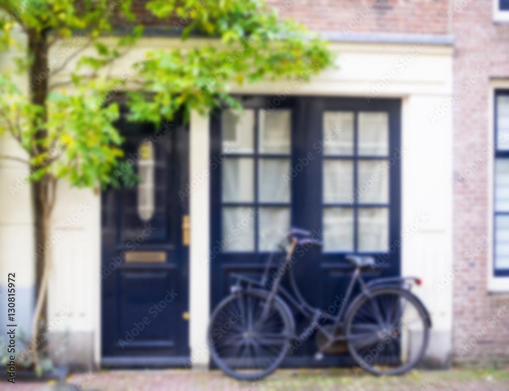 Blurred bicycle parking in front of a house