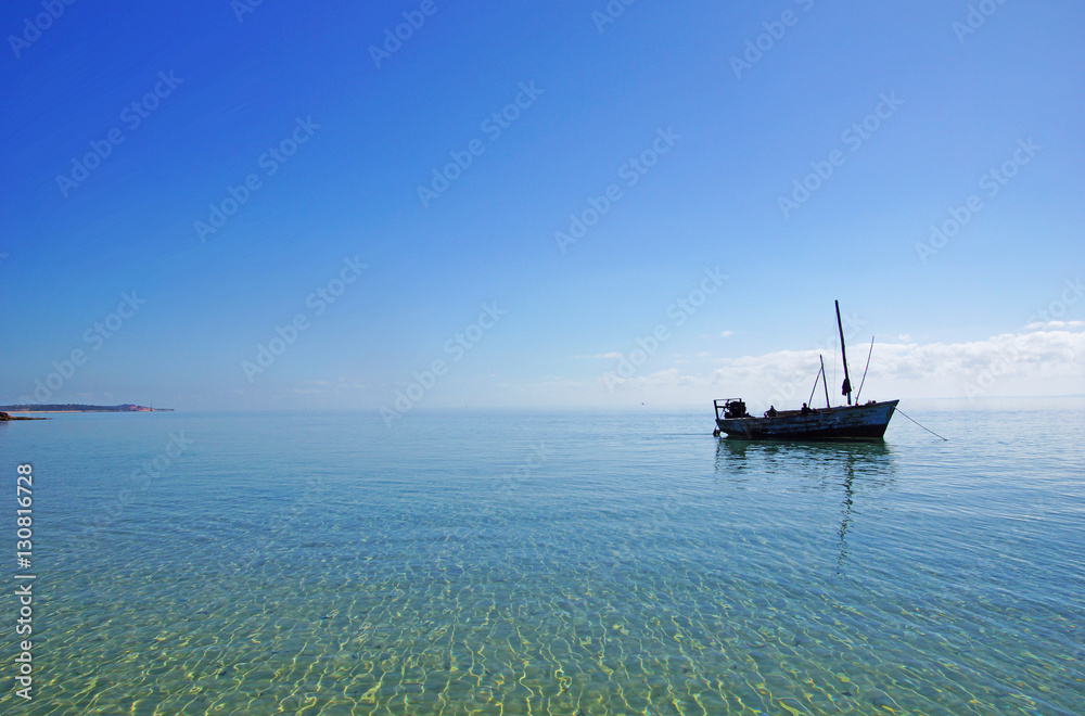 fishing boat in shallow waters of the pacific ocean