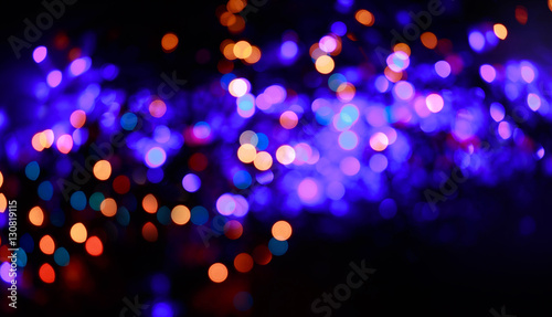 Glitter lights background. Holiday bokeh texture. Multicolored light. Defocused