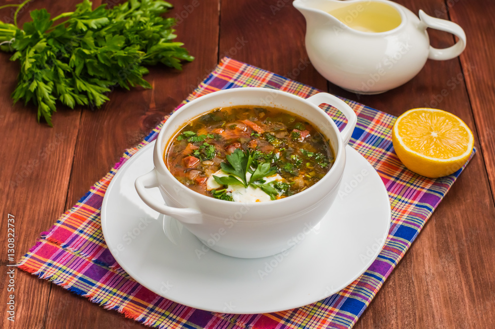 Solyanka, Russian dishes, soup on a steep meat broth with hot spices. Wooden background Solyanka, Russian dishes, soup on a steep meat broth with hot spices. Wooden background