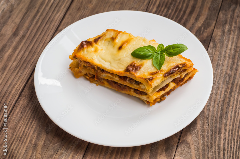 Lasagna, traditional Italian food on a wooden background