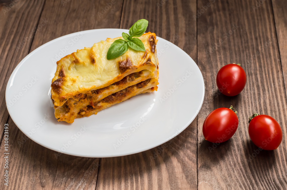 Lasagna, traditional Italian food on a wooden background