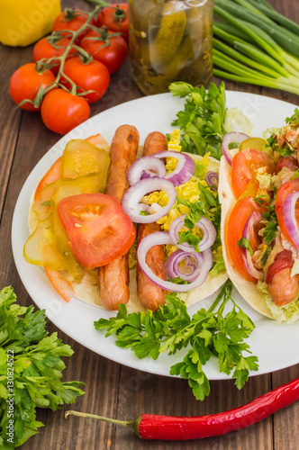 Ingredients for a picnic consisting of vegetables and sausages grilled on wooden rustic background, top view. Close-up © mahara