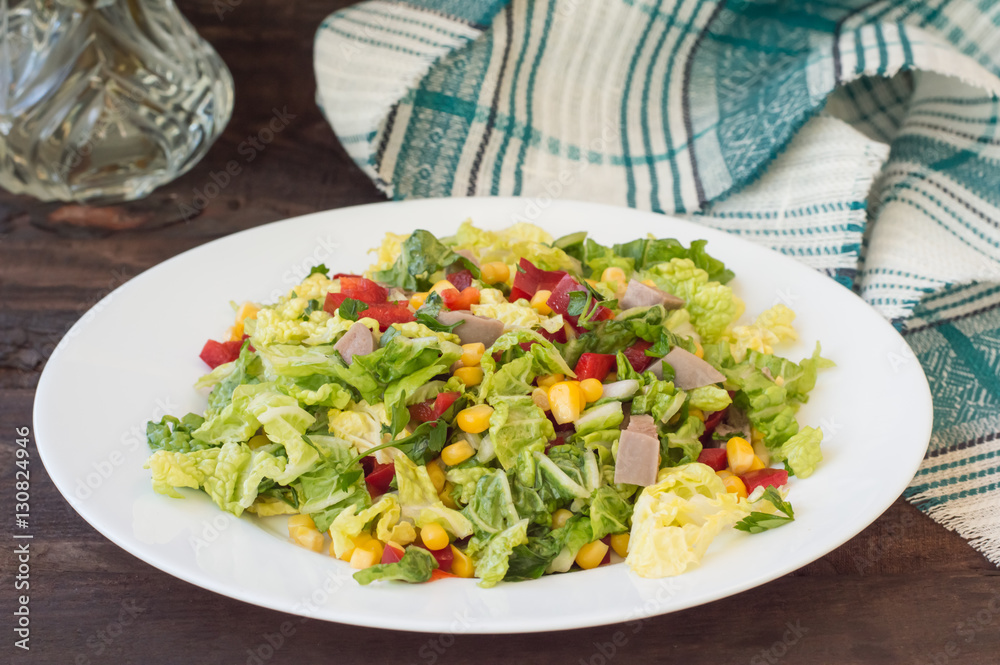 Salad from beef tongue, Chinese cabbage, peppers, corn, parsley and basil. Wooden background. Top view Salad from beef tongue, Chinese cabbage, peppers, corn, parsley and basil. Wooden background. Top view